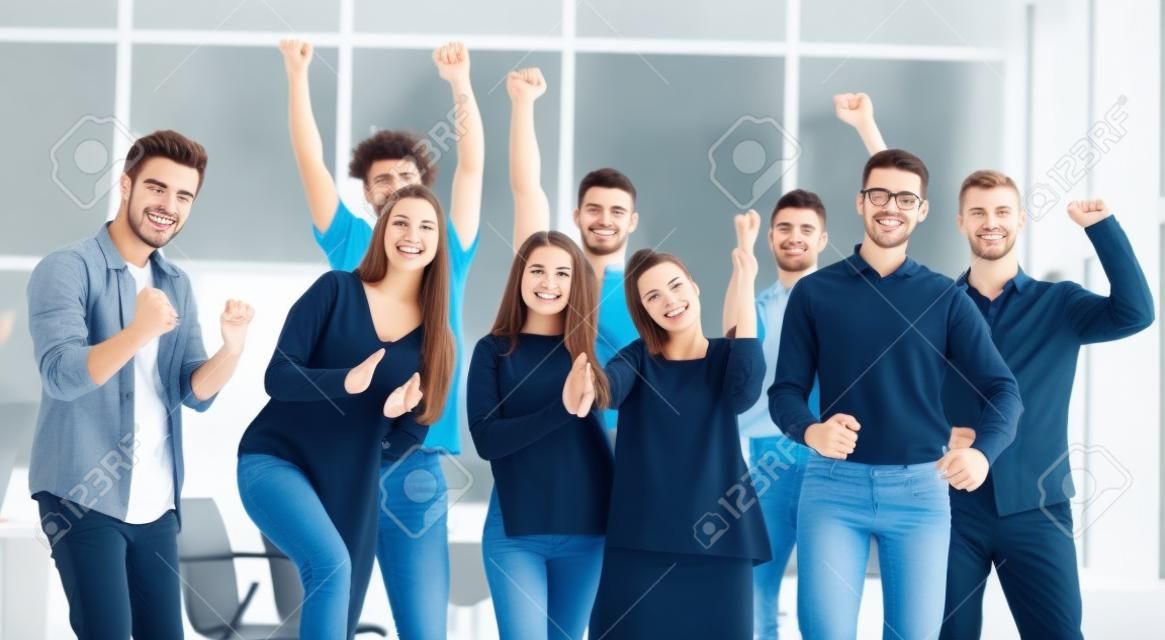 team of happy young people standing in a new office