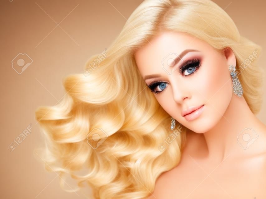 Beautiful girl blonde. Hair with an elegant hairstyle, wavy hair , curly hairstyle.  Long,nice eyelashes and big earrings.