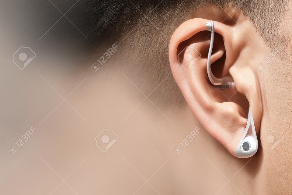 Modern digital in the ear hearing aid for deafness and the hard of hearing in aged man's ear.