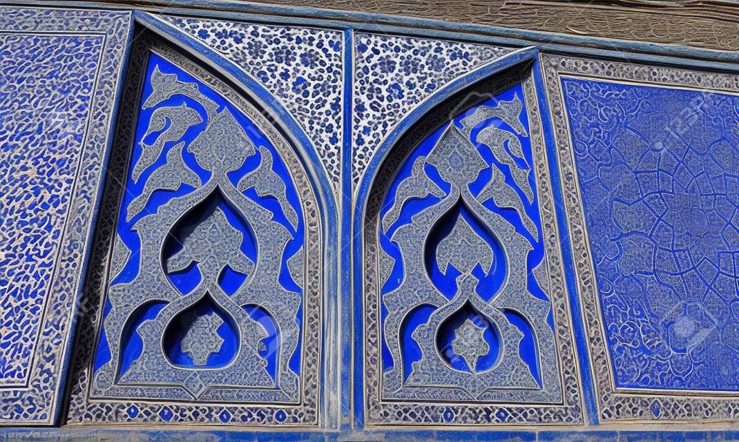 The outer wall of the South portal of historical Jameh Mosque is covered with unique tile ornaments in bright blue gamma, Isfahan, Iran.