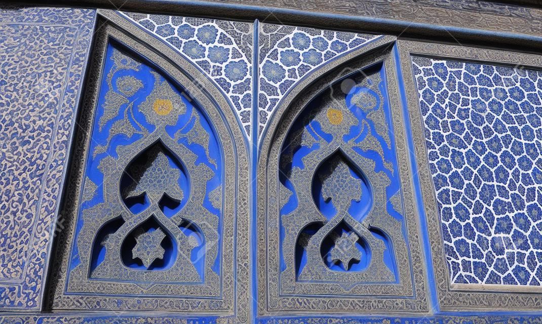 The outer wall of the South portal of historical Jameh Mosque is covered with unique tile ornaments in bright blue gamma, Isfahan, Iran.