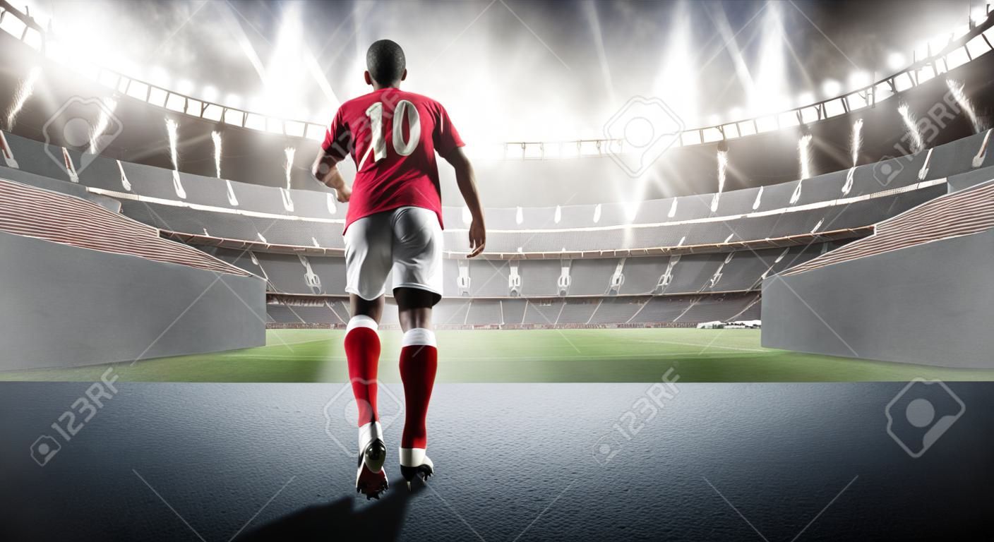 Piłkarz wchodzący na wyimaginowany stadion 3D. Wyimaginowany stadion piłkarski jest modelowany i renderowany.