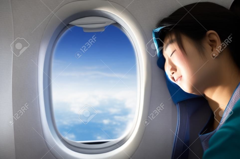 Asian woman sleeping in the airplane. Copy space.