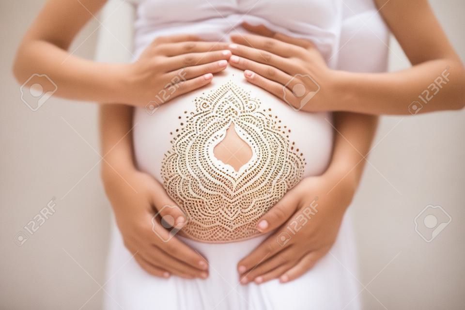 Pregnant Belly Closeup With White Henna Painting In Boho Style