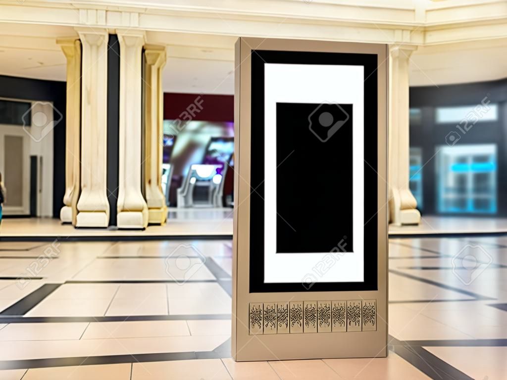 Empty indoor portrait digital signage light box with blurred mall background. Ideal for digital advertisement, information board, mall ads, video wall and large posters for campaigns