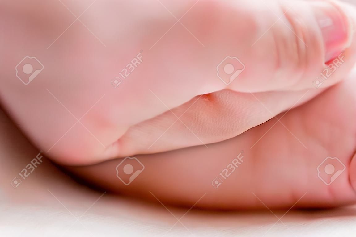 hand of a newborn baby close up. folds baby hand