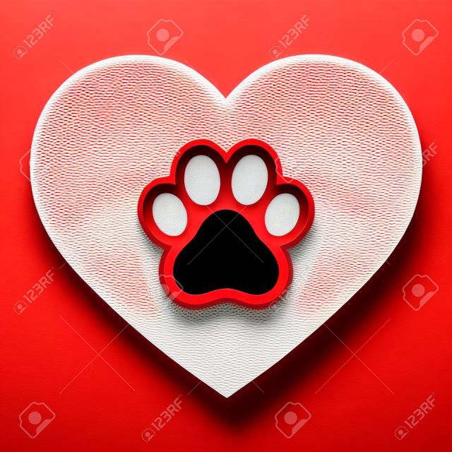 dog paw in red heart on white background