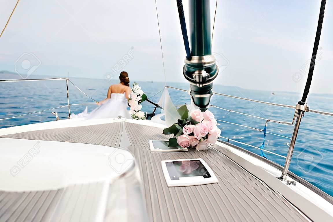 Just married couple on yacht. Happy bride and groom on their wedding day,