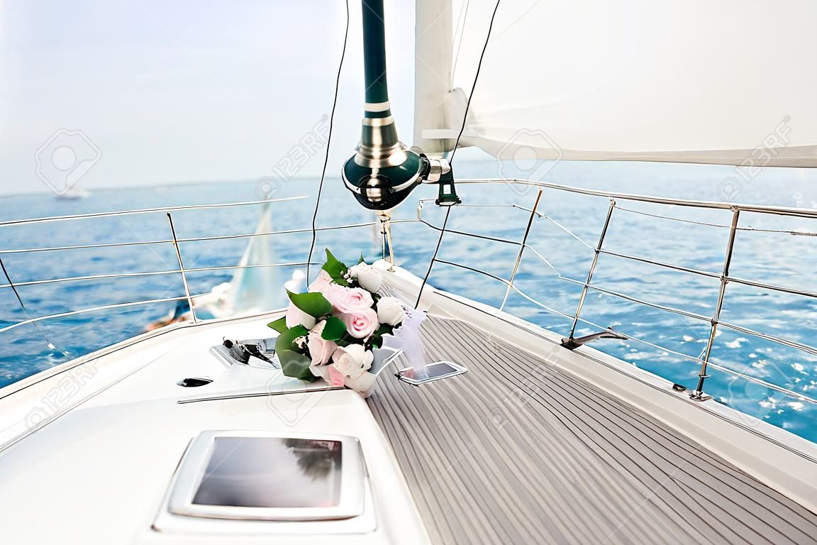 Just married couple on yacht. Happy bride and groom on their wedding day,
