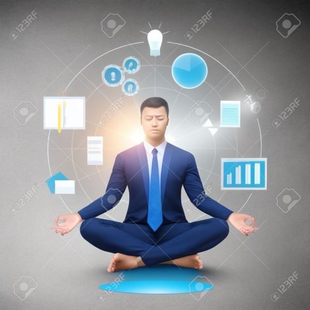 Businessman practicing mindfulness meditation; yoga and self consciousness concept