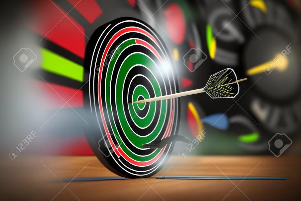 Close up shot of the dart arrow hit on bull eyes of dartboard to represent that the business reached the target of company. Target and goal as concept. Goal setting with target. Close-up dart targets.