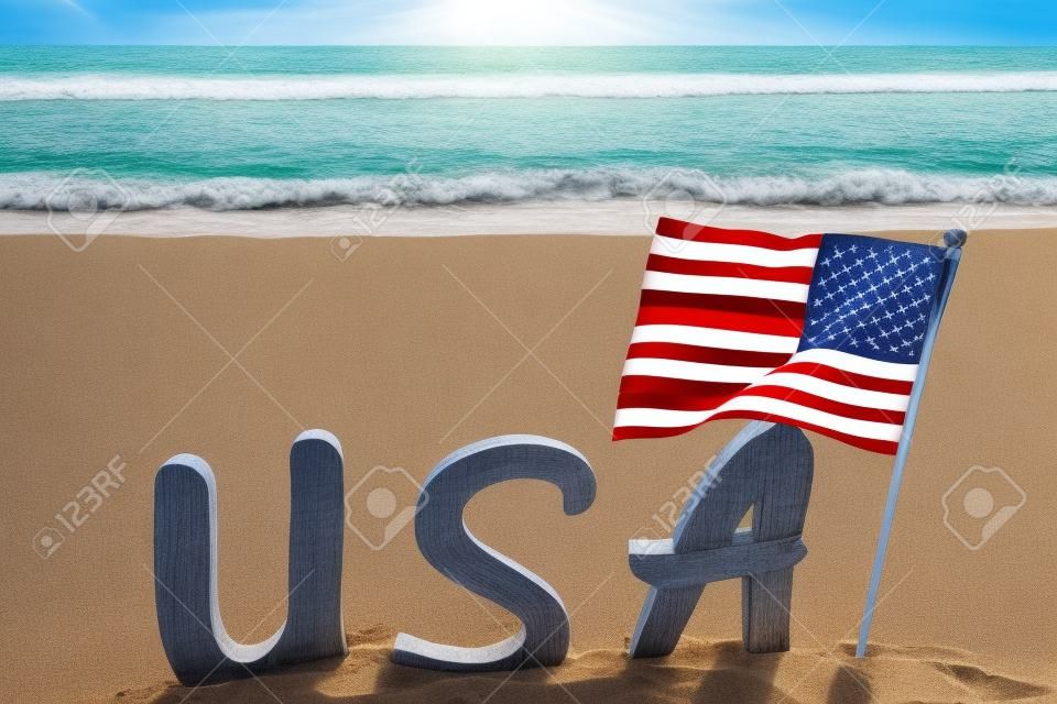 Patriotic USA background with flag on the sandy beach near ocean