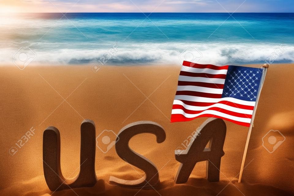 Patriotic USA background with flag on the sandy beach near ocean