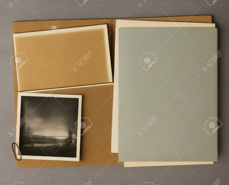 Open vintage folder with two old photographs