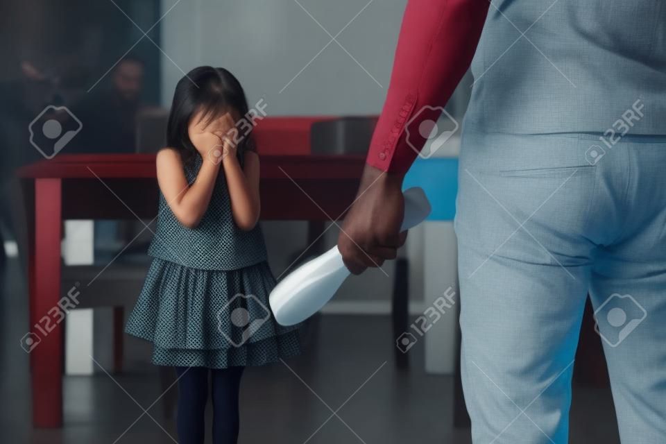 The angry father punishing his daughter