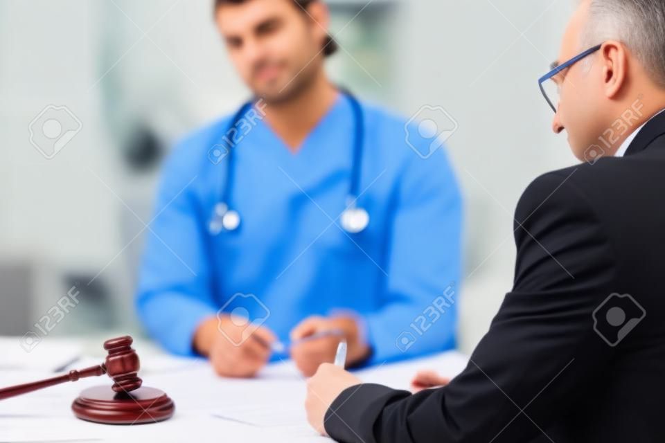 Male doctor in courthouse meeting with lawyer