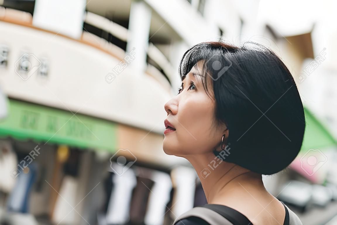 mature Asian woman wait and see, concept of dream, hope, confident etc