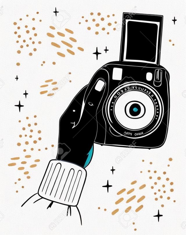 Illustration hand holds instant print camera. The picture goes out of the camera. Black outline on white background.