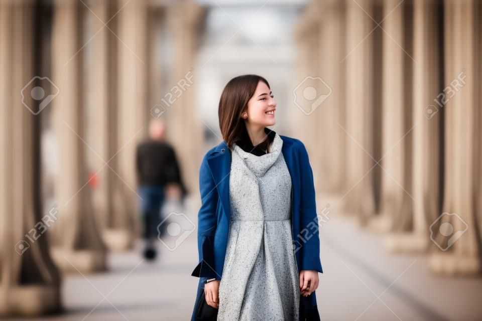 Beautiful young girl on Bir-Hakeim bridge on a fall or spring day. Paris, France