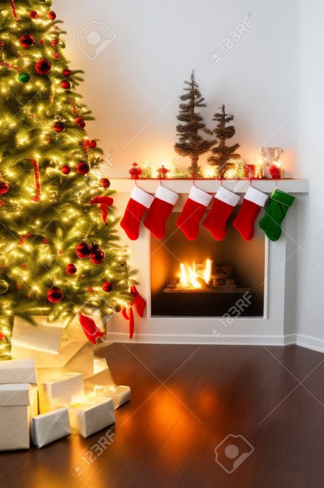 Front room decorated for christmas with christmas tree stockings and fireplace