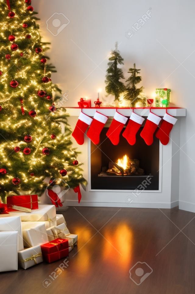 Front room decorated for christmas with christmas tree stockings and fireplace
