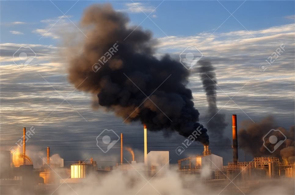 Factory smokestack chimney piping smoke or steam into the air pollution