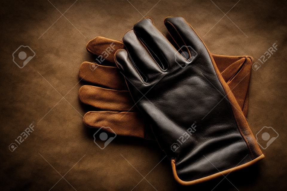 Detail of old worn leather work gloves workgloves texture