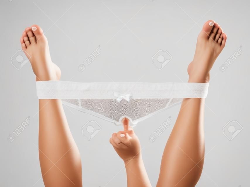 Woman Holding Legs Up With Hand In Panties Isolated On White Background  Banco de Imagens Royalty Free, Ilustrações, Imagens e Banco de Imagens.  Image 15608201.