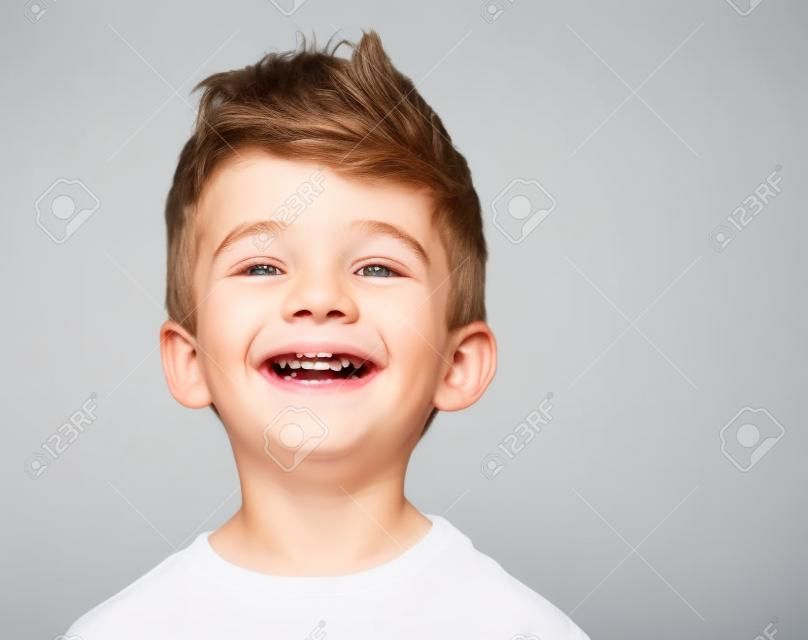 Happy young boy with smile on his face on white
