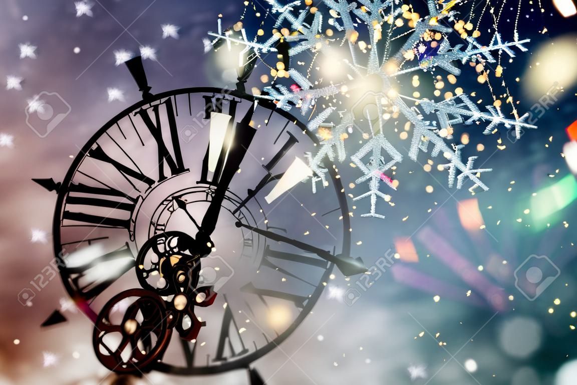 Capodanno a mezzanotte - Vecchio orologio con stelle fiocchi di neve e luci natalizie