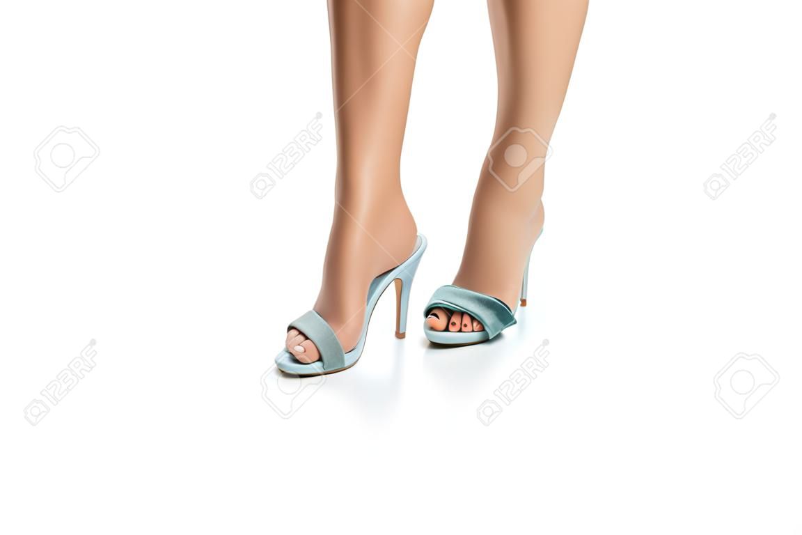 Twist ankle. Woman in blue high heels shoes on white background. ankle sprain.