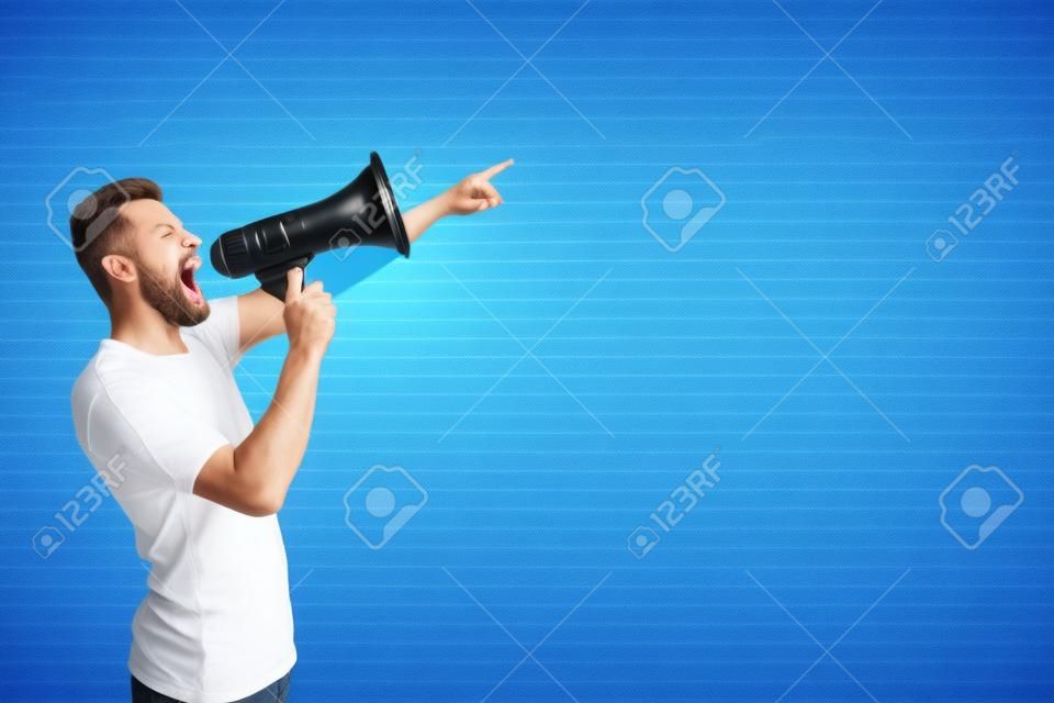 A picture of man standing and pointing forward. He is talking and screaming into megaphone. Isolated on striped and blue background.