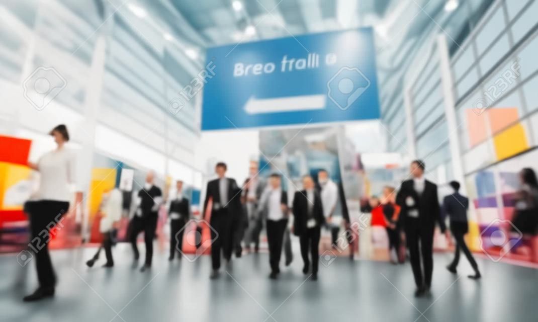 blurred people at a trade fair hall