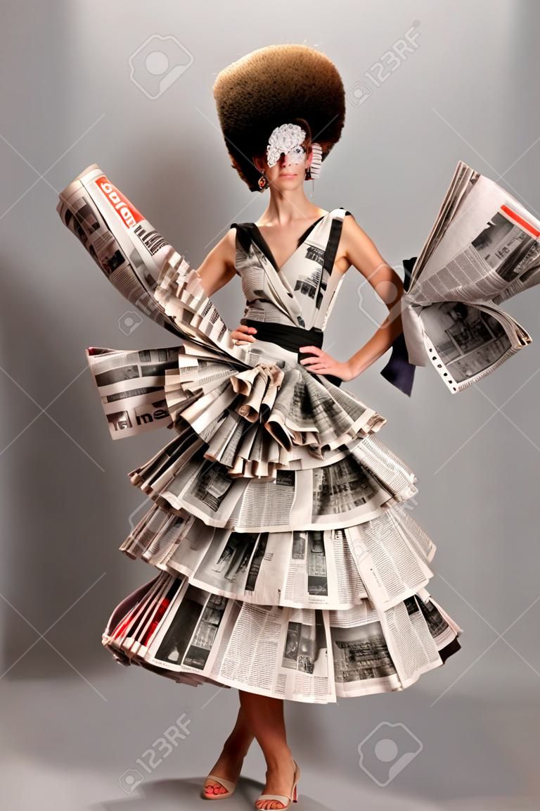 Ritratto di una bella ragazza in un vestito di giornale