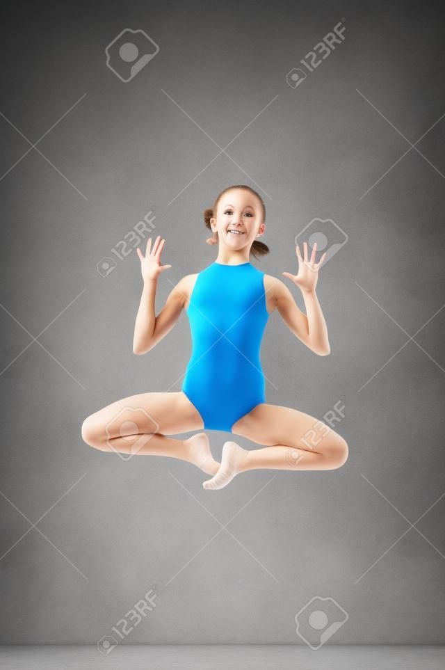 Gymnast girl jumping studio