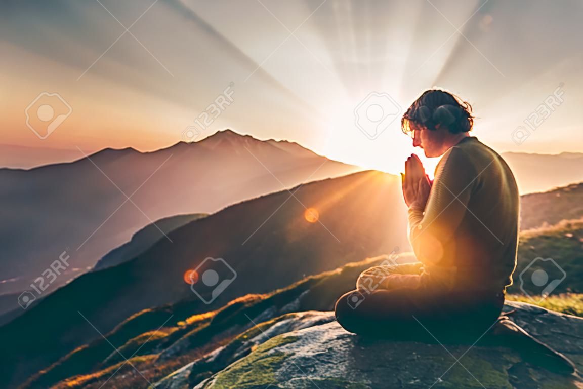 Hombre rezando al atardecer montañas Viajes Estilo de vida relajación espiritual concepto emocional vacaciones al aire libre armonía con el paisaje de la naturaleza