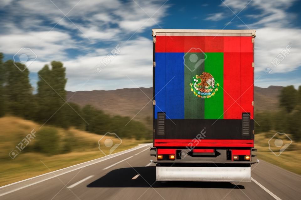 A  truck with the national flag of Mexico
 depicted on the back door carries goods to another country along the highway. Concept of export-import,transportation, national delivery of goods