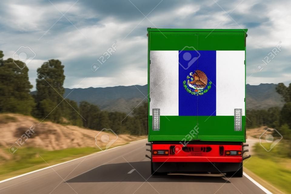 A  truck with the national flag of Mexico
 depicted on the back door carries goods to another country along the highway. Concept of export-import,transportation, national delivery of goods
