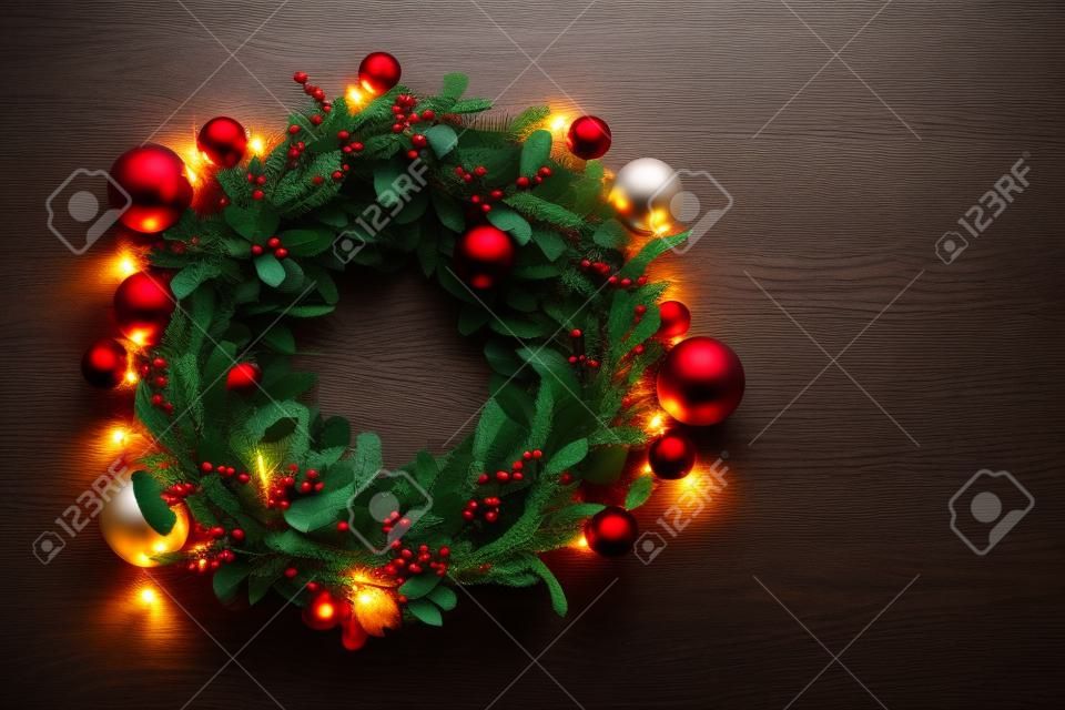 인사말 시즌 개념. 어두운 나무 배경에 장식 빛을 가진 크리스마스 화 환