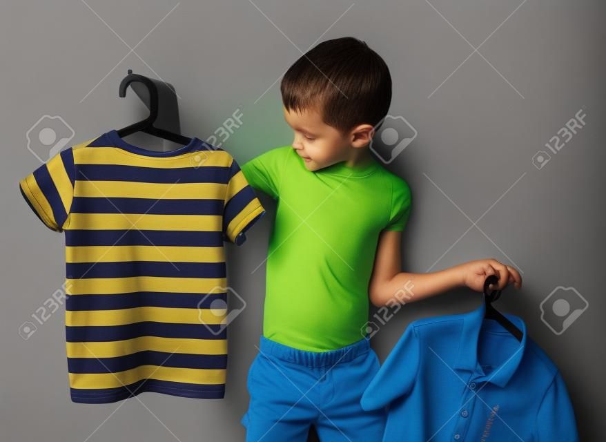 shirt or t-shirt. the boy chooses that to wear a t-shirt or shirt