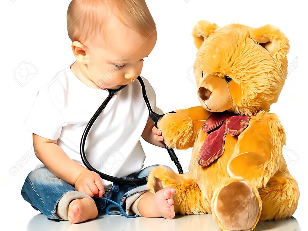 baby plays in doctor toy bear and stethoscope