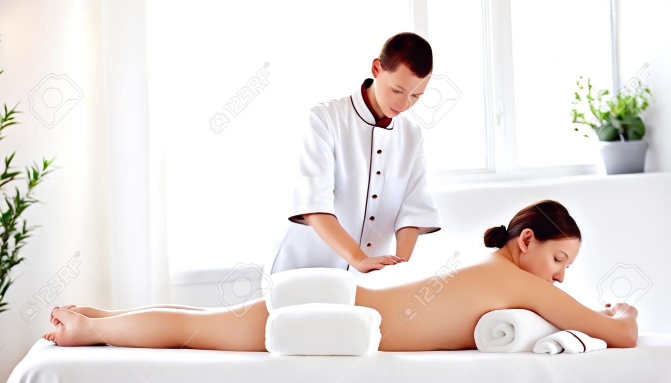 A beautiful girl enjoys massage and spa treatments