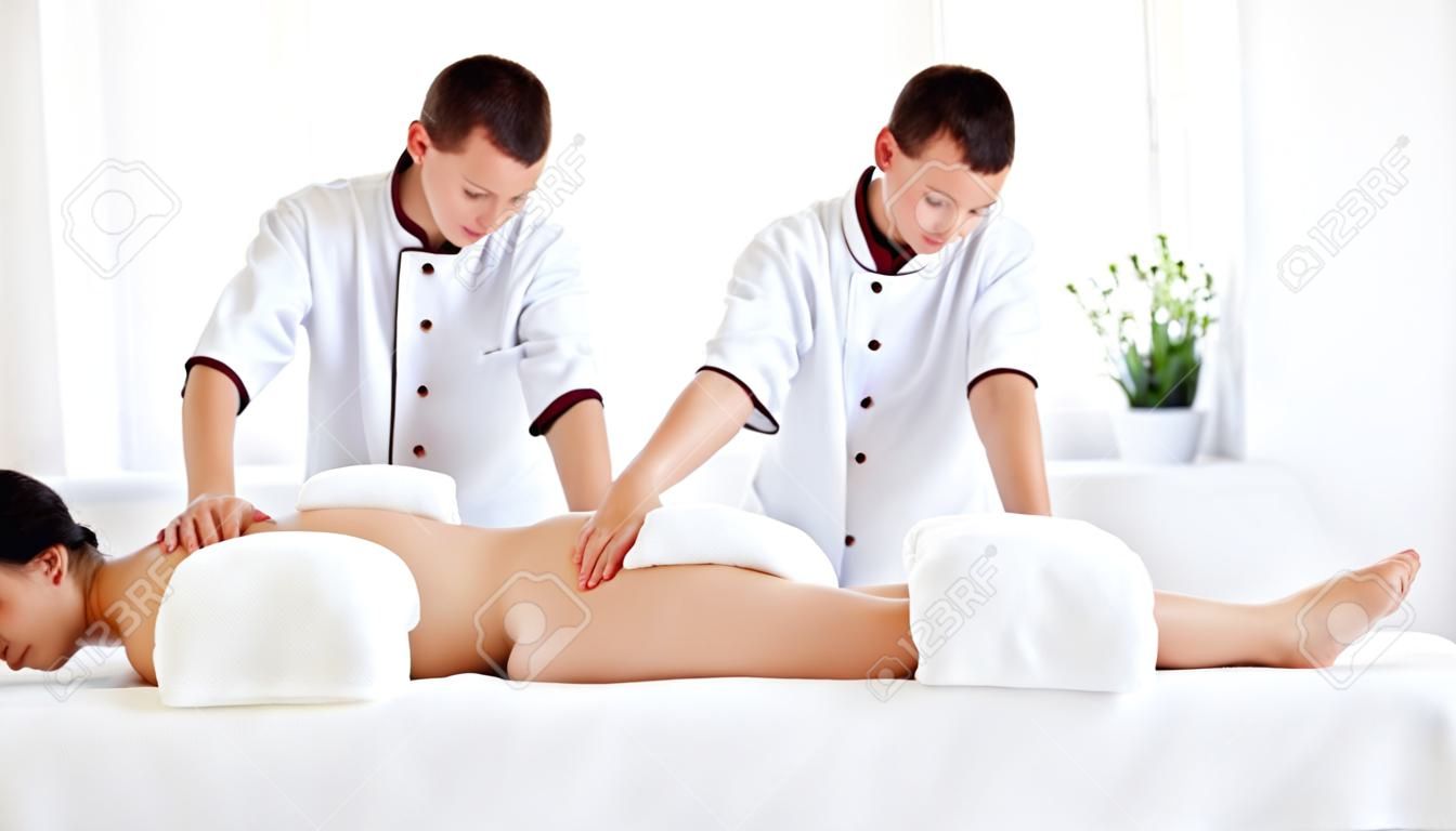 A beautiful girl enjoys massage and spa treatments