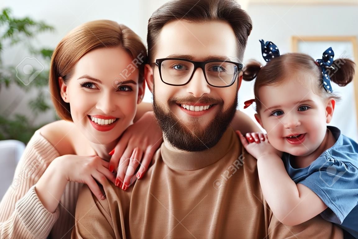 Cheerful happy family mother, father and child take selfies, take pictures at home