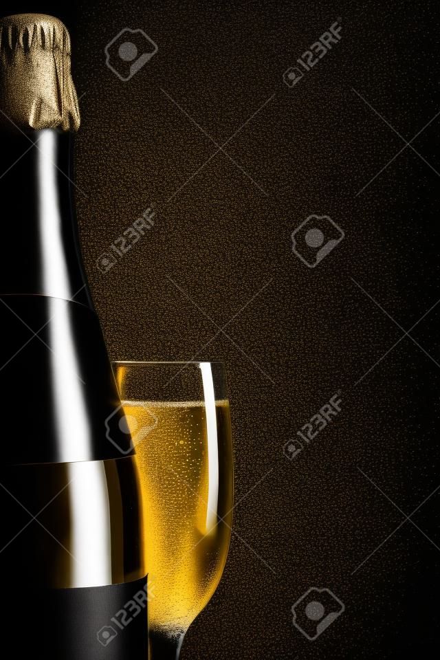 champagne wine glass and bottle on black background