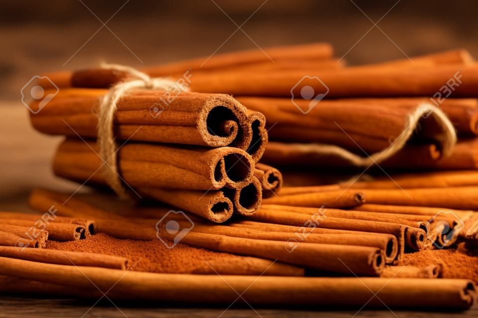 Cinnamon sticks on wooden background. Creative Photo