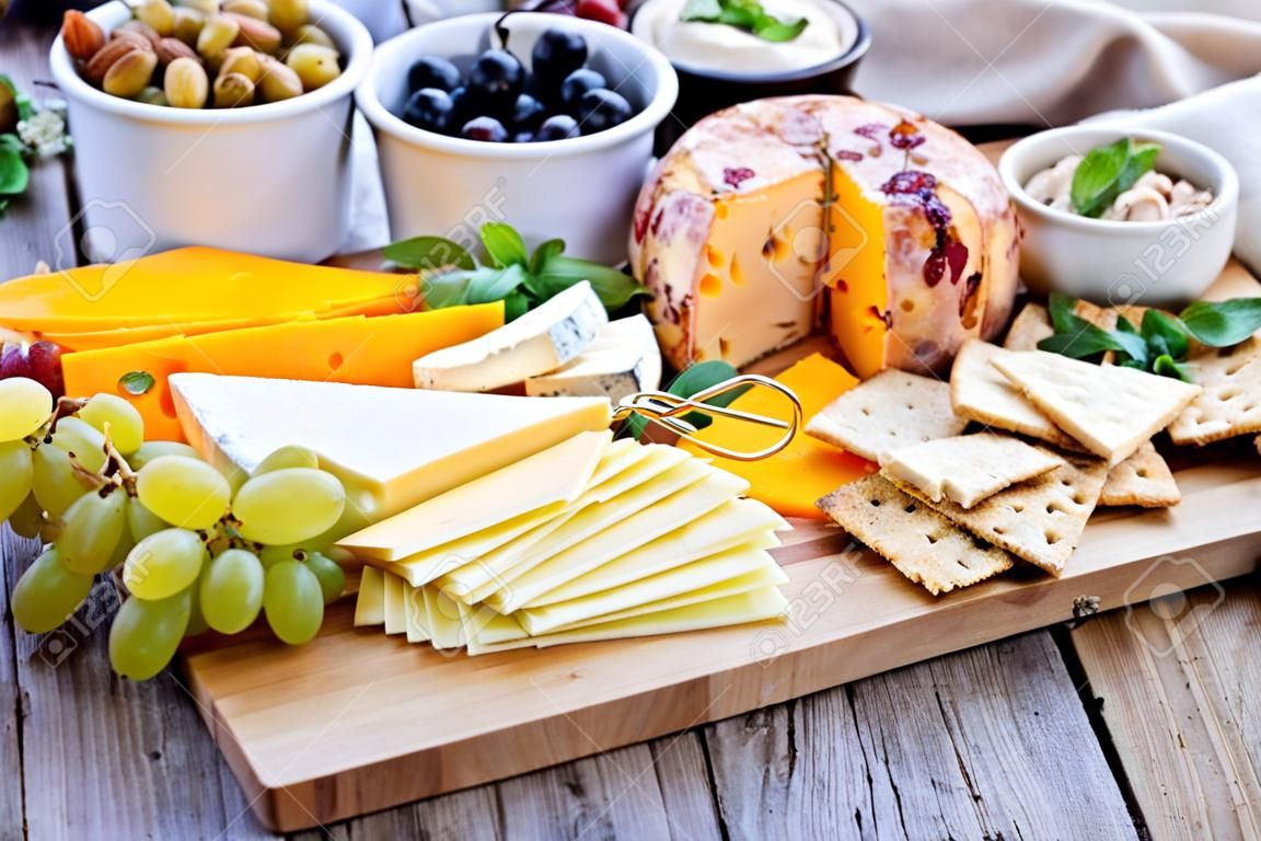 Cheese plate with many foods on a table
