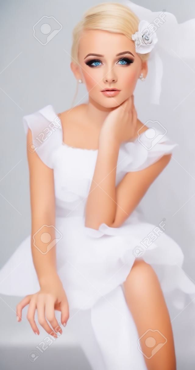 Elegant Young Blond Girl Posing in a Formal Dress