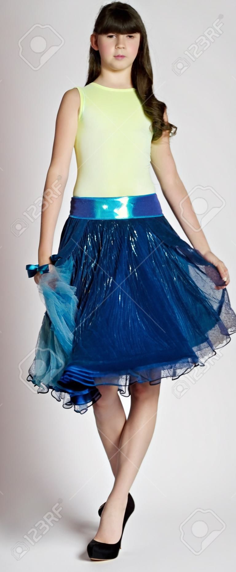 Teen Girl in a Skirt and Heels Against a White Studio Background