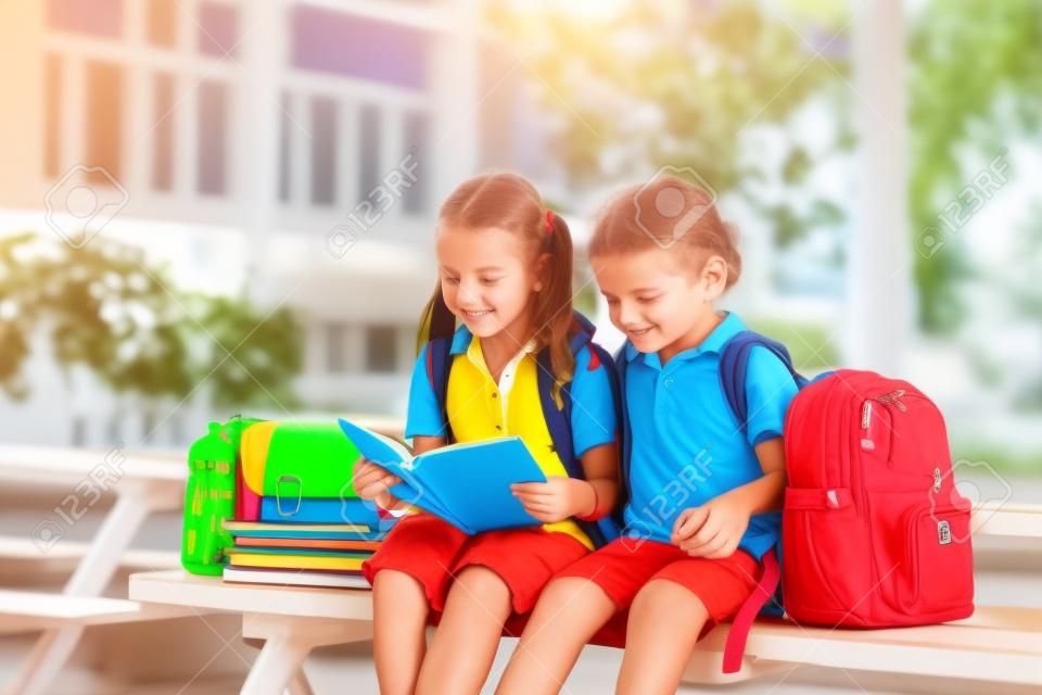 Children go back to school. Start of new school year after summer vacation. Boy and girl with backpack and books on first school day. Beginning of class. Education for kindergarten and preschool kids.